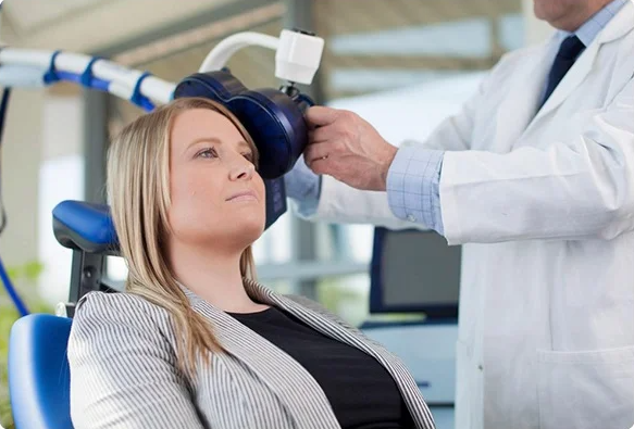 A woman undergoing MagStim Repetitive TMS treatment